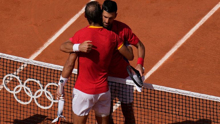 Serbia's Novak Djokovic, right, hugs Spain's Rafael Nadal after their...