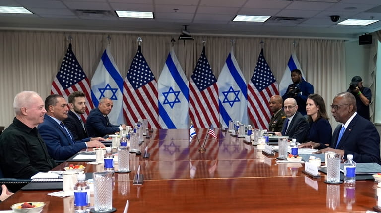 Defense Secretary Lloyd Austin, right, and Israeli Defense Minister Yoav...