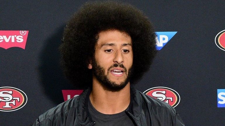 Colin Kaepernick of the San Francisco 49ers speaks to media...