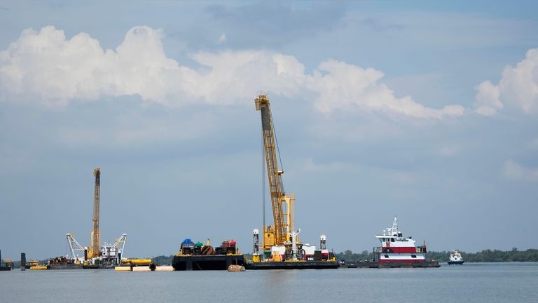 Work in the Mississippi River is seen where sills are...