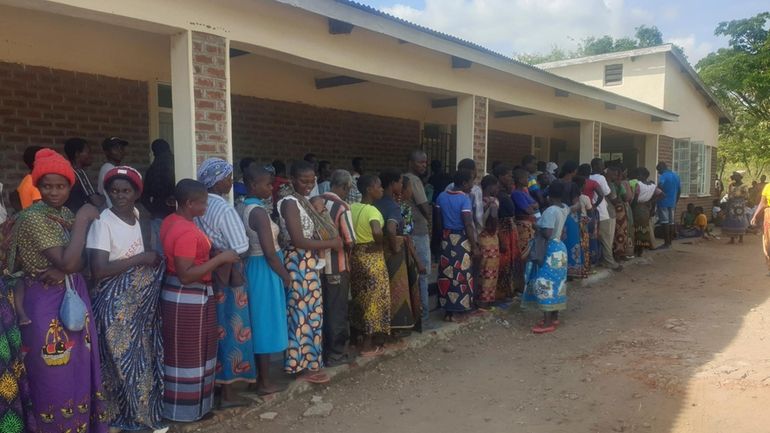 People queue for food at a World Food Programme distribution...