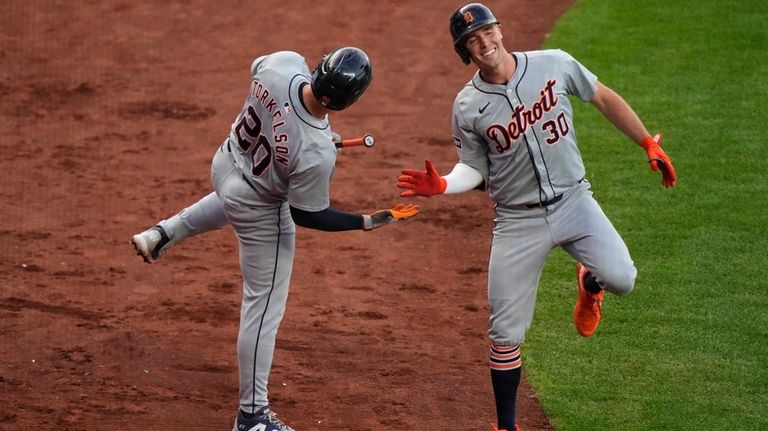 Detroit Tigers' Kerry Carpenter (30) celebrates with Spencer Torkelson (20)...