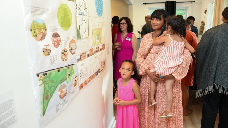 Sienna Hunter-Cuyjet and her two daughters look at Sequoyah Hunter-Cuyjet's...