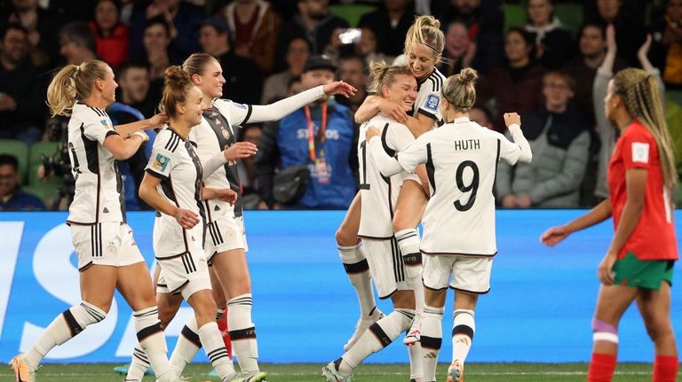 Germany players celebrate after Germany's Alexandra Popp, 4th right, scored...