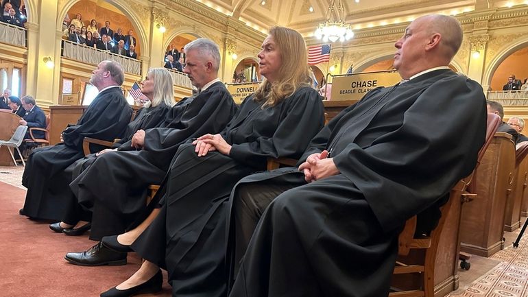 Justices of the South Dakota Supreme Court listen to Gov....