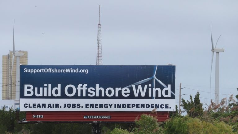 A billboard supporting offshore wind power projects sits on a...