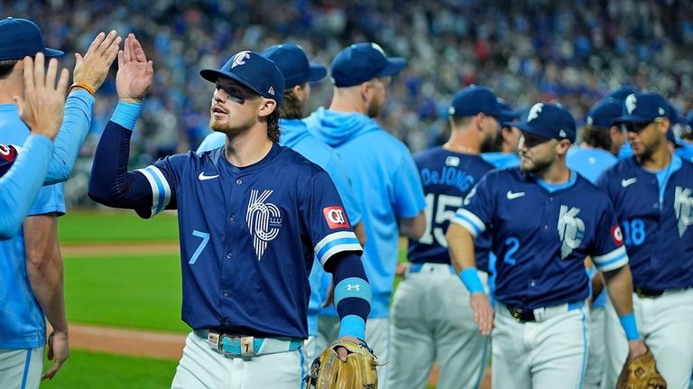 Kansas City Royals shortstop Bobby Witt Jr. celebrates with teammates...