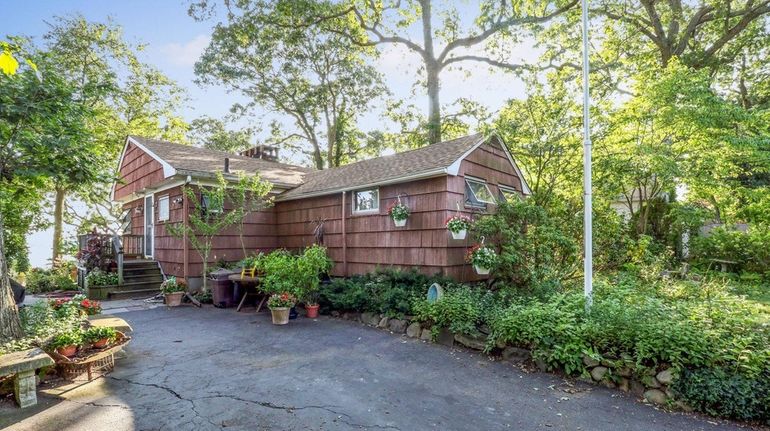 This Eatons Neck home has a living room with water...