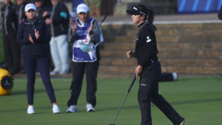 Lydia Ko, of New Zealand, reacts on the 18th green...