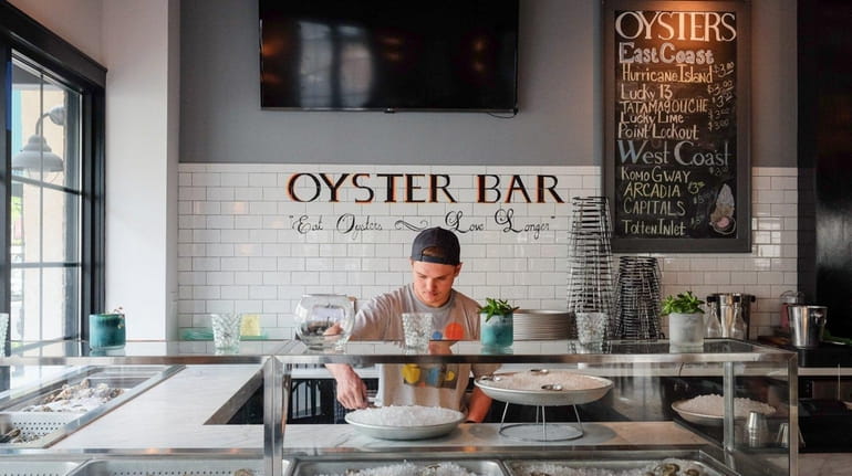 Peter Wills shucks oysters at the oyster bar inside of...