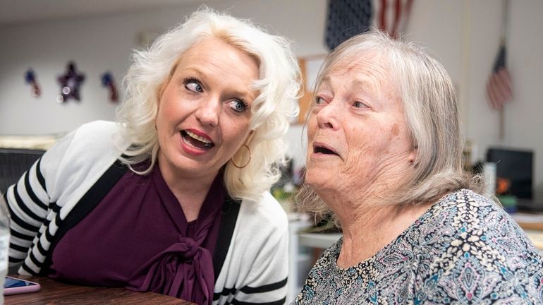 VNA Caring Center Director Angela Loeper, left, sings an oldies...