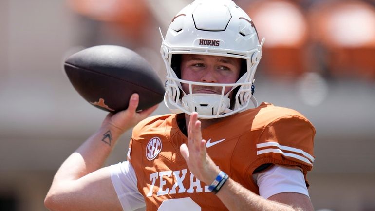 Texas quarterback Quinn Ewers (3) throws before an NCAA college...