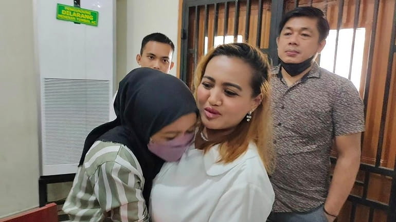 Un identified relative hugs Lina Lutfiawati, who is also known...