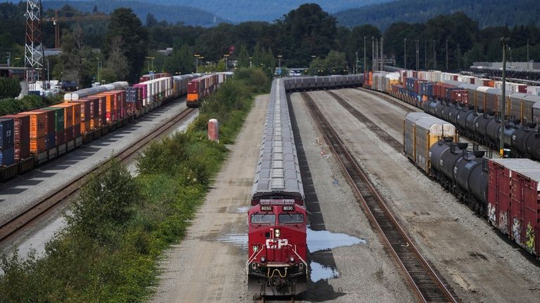 A locomotive moves rail cars at the Canadian Pacific Kansas...