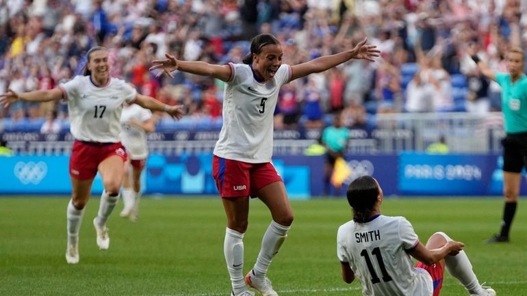 United States' Sophia Smith celebrates with team mates the opening...