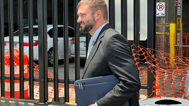 Assistant U.S. Attorney David O'Neal leaves the federal courthouse in...