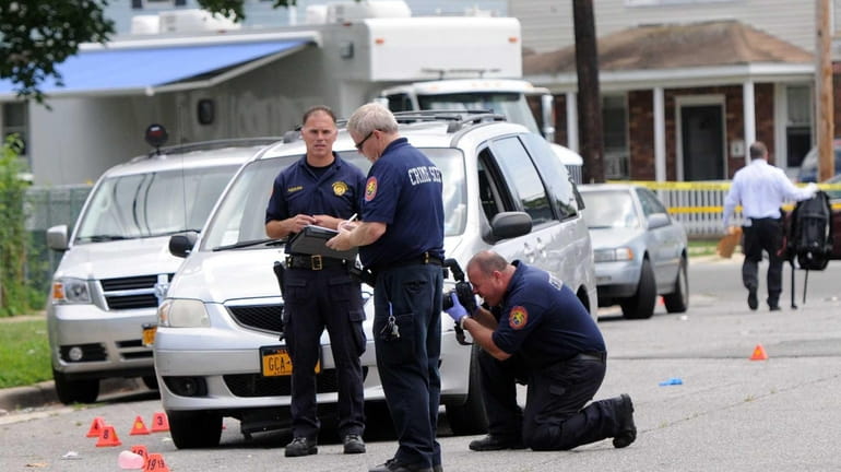 Nassau County police investigate the scene of a shooting in...