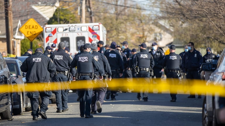 NYPD officers at the scene of a shooting in Queens...