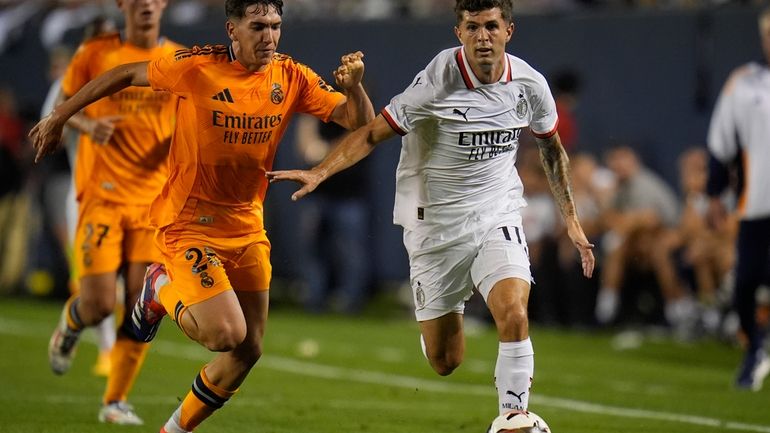 Real Madrid midfielder Mario Martín, left, and Milan forward Christian...