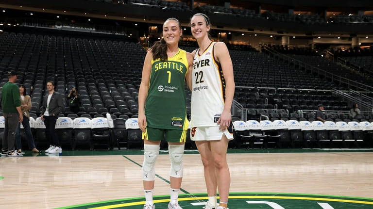 Seattle Storm guard Nika Muhl, left, and Indiana Fever guard...