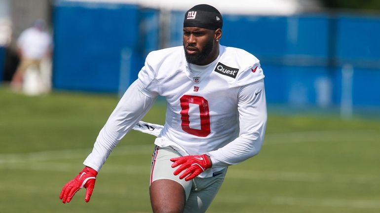 Giants edge rusher Brian Burns dioes a drill during training...