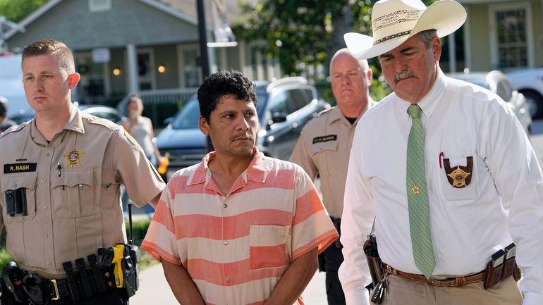 Francisco Oropeza, center, is escorted to the San Jacinto County...