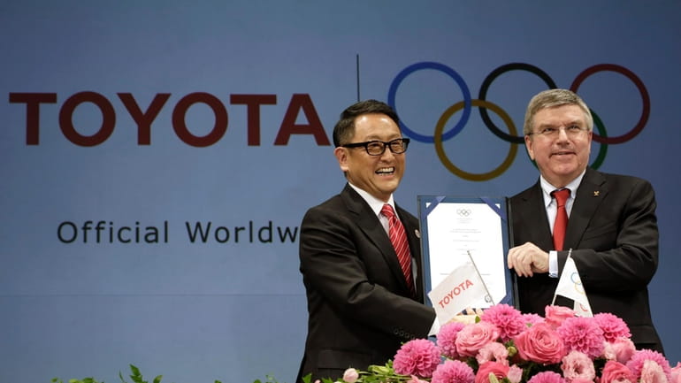 Toyota President and CEO Akio Toyoda, left, and IOC President...