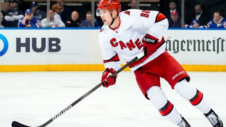 Carolina Hurricanes center Martin Necas (88) skates with the puck...