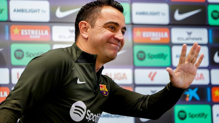 Barcelona's head coach Xavi Hernandez gestures during a press conference...