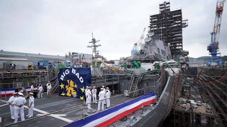 The USS John S. McCain, under repair at a dry...