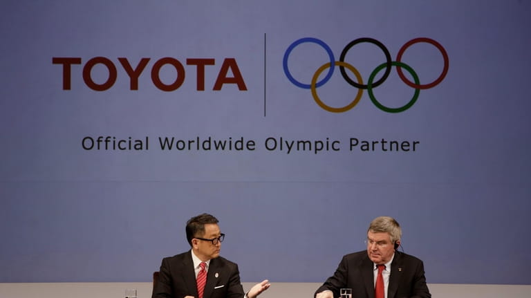 International Olympic Committee (IOC) Thomas Bach, right, and Toyota President...
