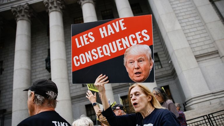 People protest against former President Donald Trump before his arrival...