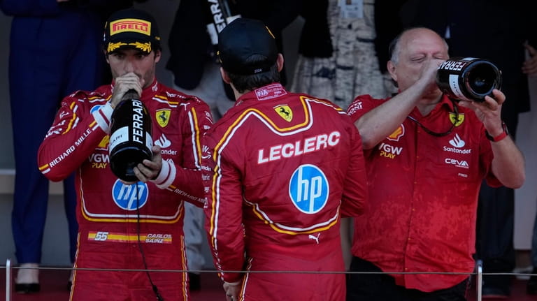Ferrari driver Charles Leclerc of Monaco, centre, celebrates on the...