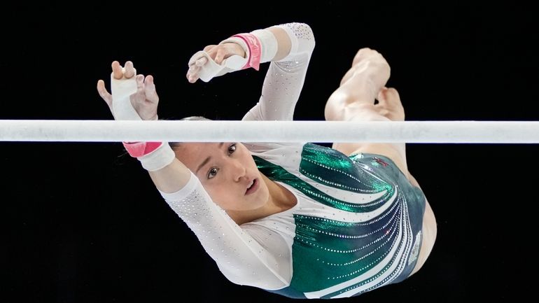 Algeria's Kaylia Nemour competes on the uneven bars to win...