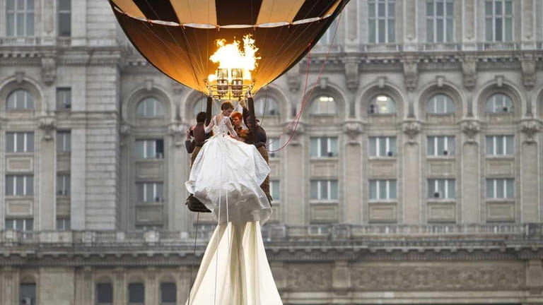 A model rides in a hot air balloon to show...