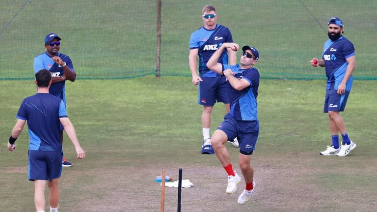 New Zealand's captain, Tim Southee, second right, along with teammates...