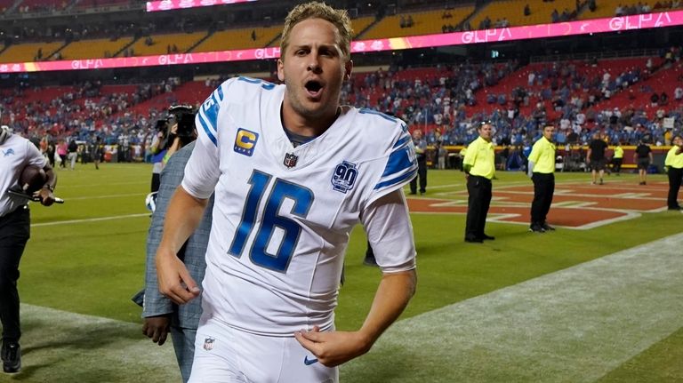 Detroit Lions quarterback Jared Goff celebrates as he runs off...