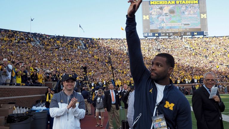 Former Michigan wide receiver Braylon Edwards is recognized by the...