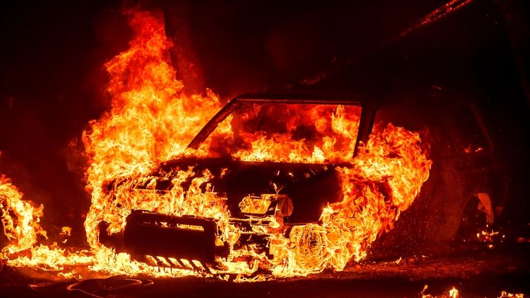 Flames consume a vehicle as the Park Fire jburns in...