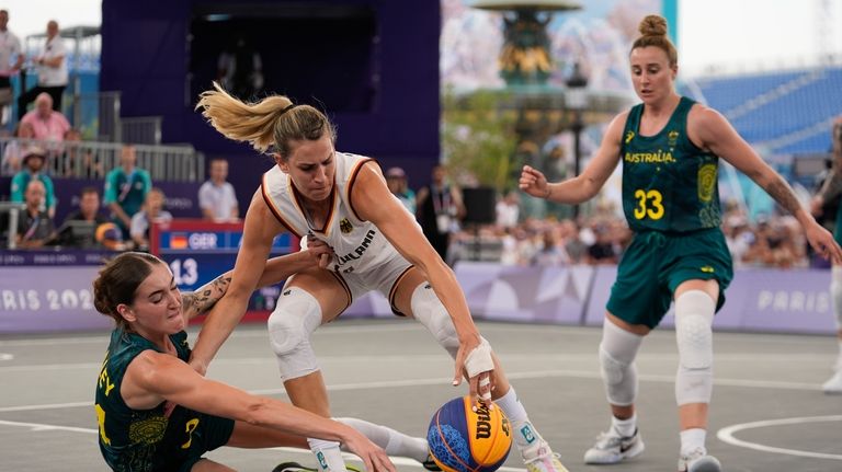 Germany's Sonja Greinacher, center, battles for the ball with Australia's...