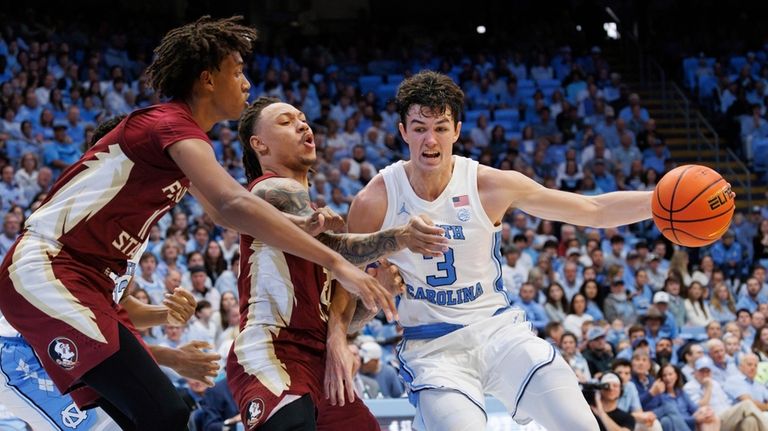 North Carolina's Cormac Ryan (3) handles the ball as Florida...