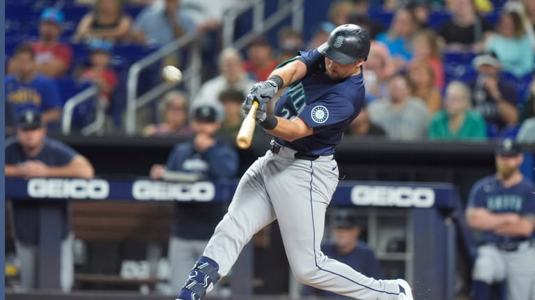 Seattle Mariners' Cal Raleigh hits a sacrifice fly ball to...