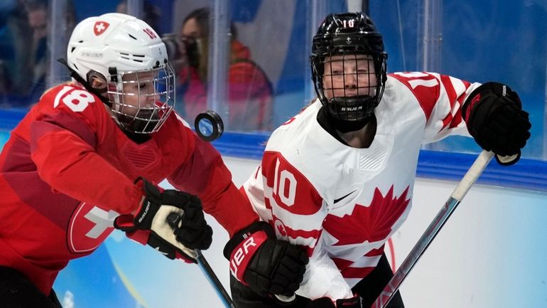 FILE -Switzerland's Stefanie Wetli (18) and Canada's Sarah Fillier (10)...