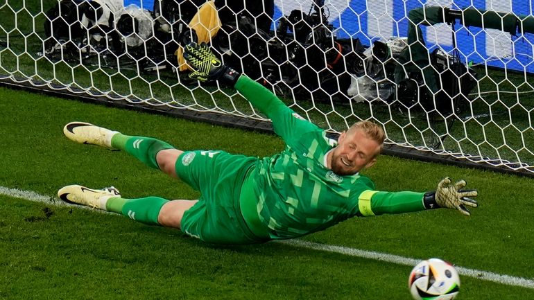 Denmark's goalkeeper Kasper Schmeichel fails to save the ball as...