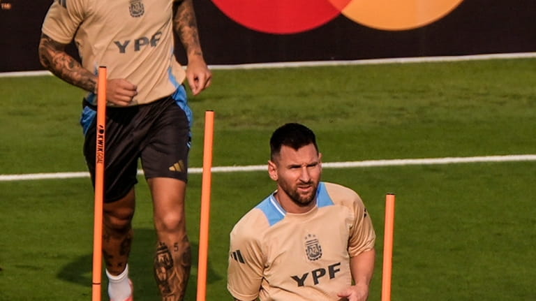 Lionel Messi, right, works out with his team, Argentina, before...