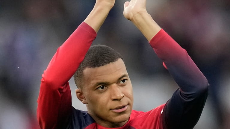 PSG's Kylian Mbappe greets supporters before the French League One...
