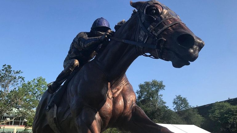 A smoke-free sky surrounds a statue of legendary racehorse Secretariat, which won the...