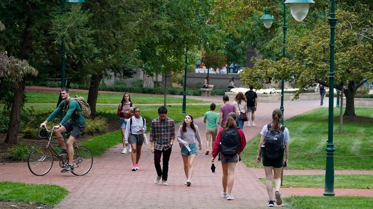 Students walk to and from classes on the Indiana University...