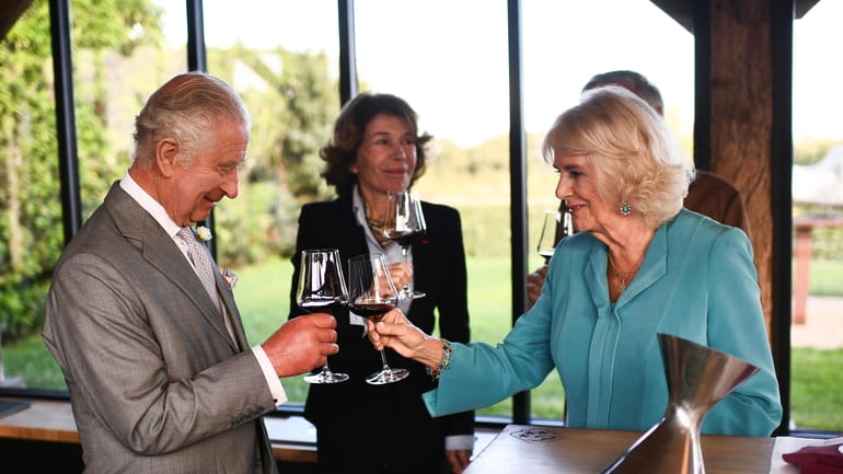 Britain's King Charles III toast with Queen Camilla during a...