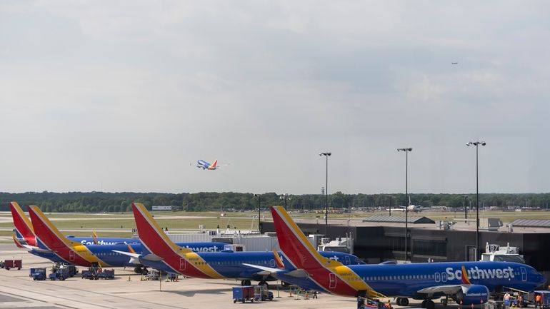 Southwest Airlines planes can be seen on the terminal at...